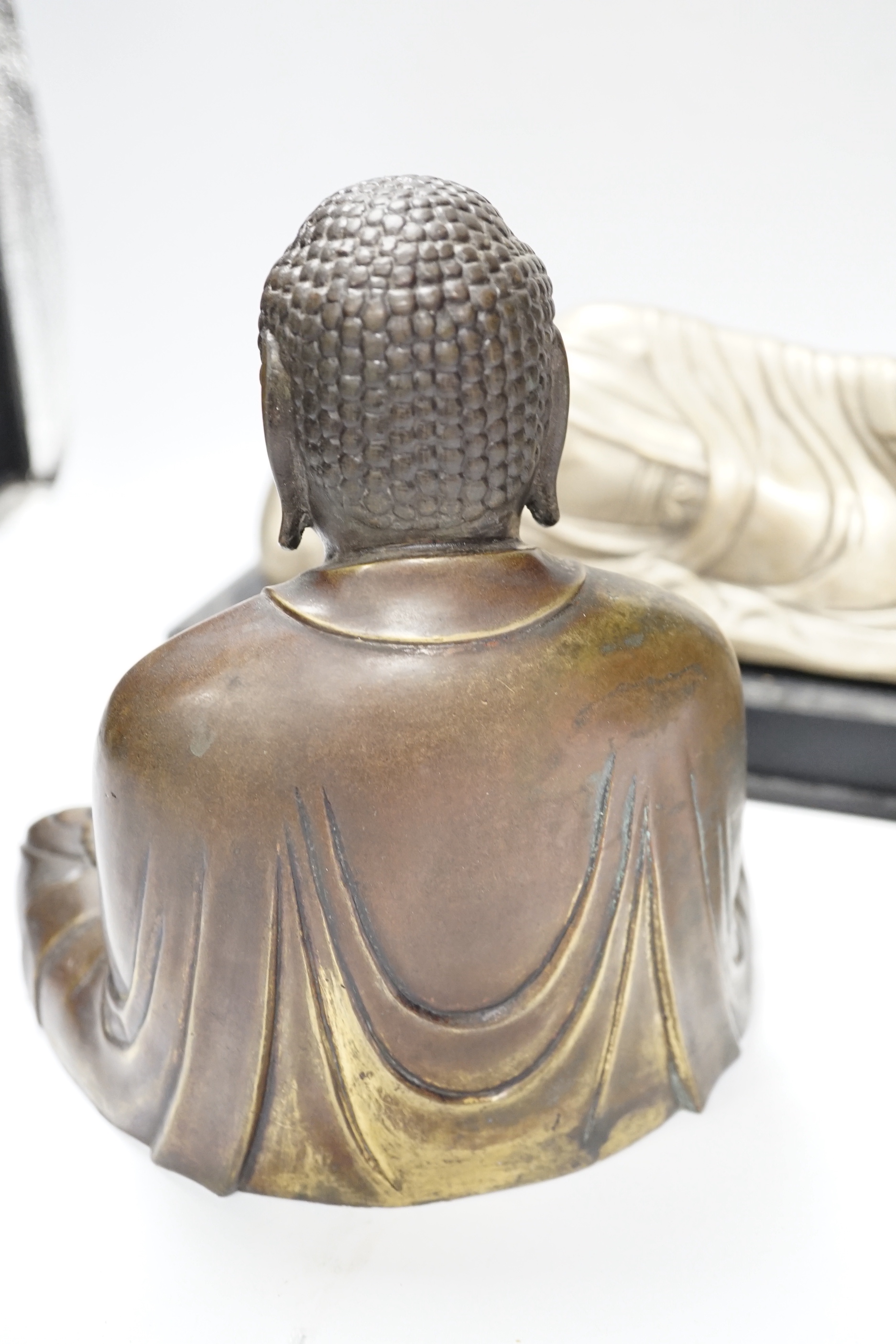 Three bronze and other metal figures of the Buddha and a Tibetan figure of Yamantaka, tallest 21.5cm